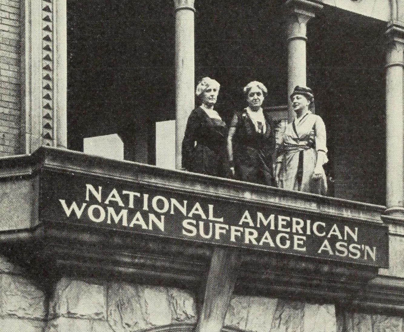 Suffragettes on the balcony of the National American Woman Suffrage Association building.