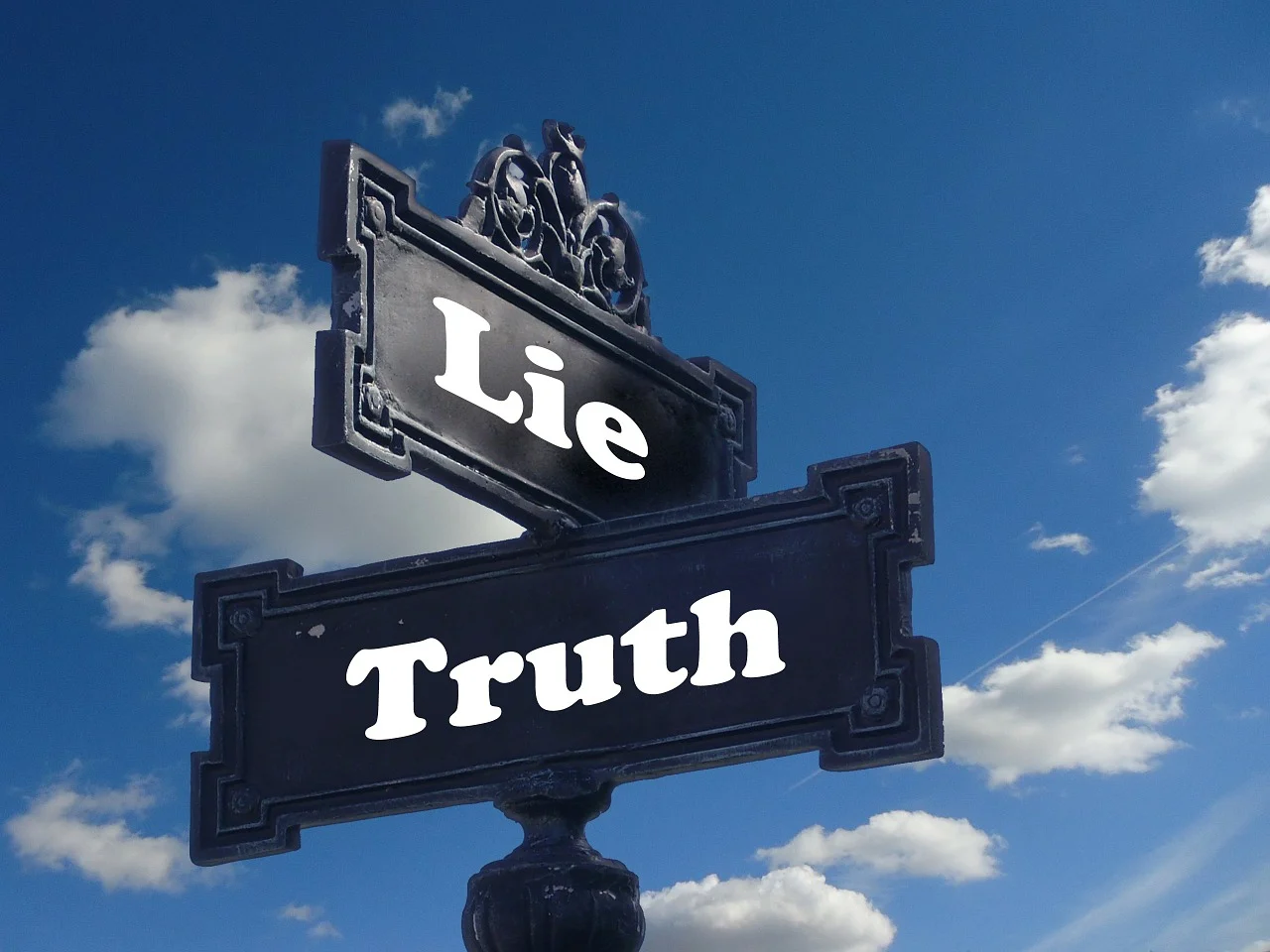 Street signs that say "lie" and "truth."